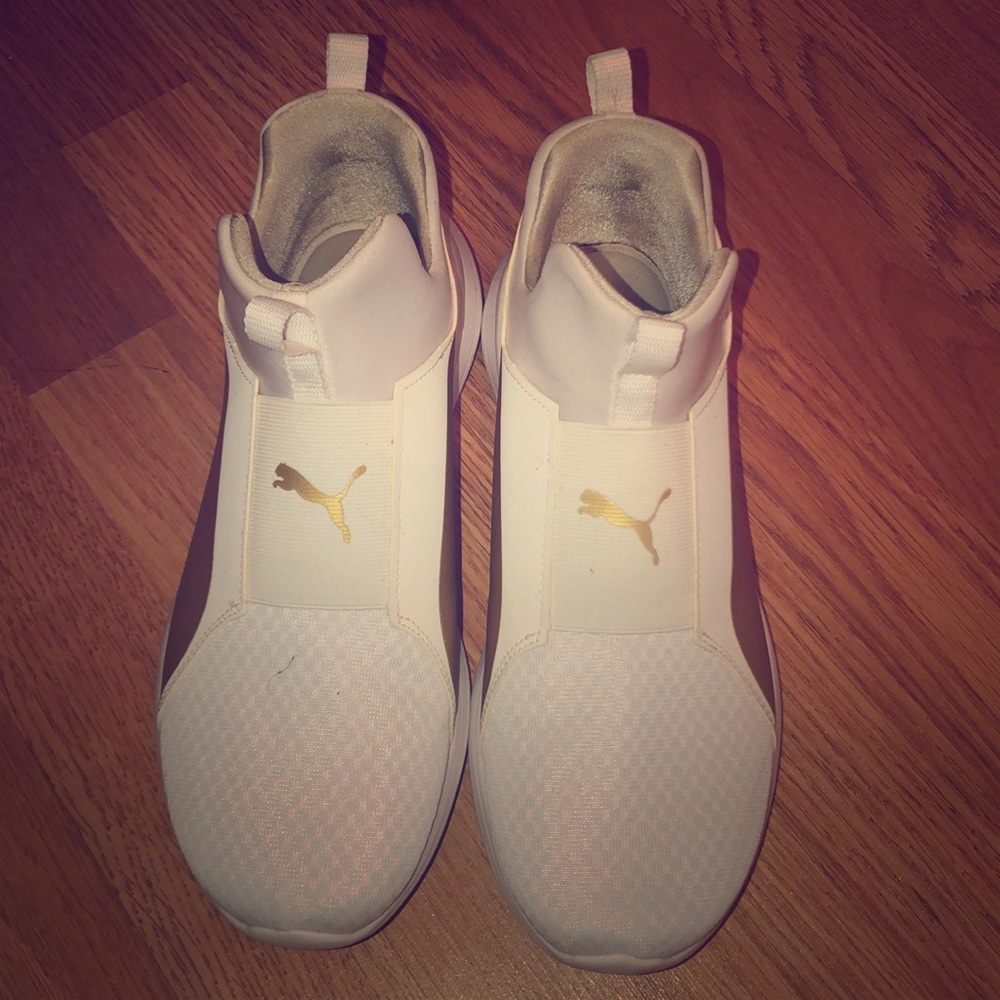 Women white and gold Pumas.
